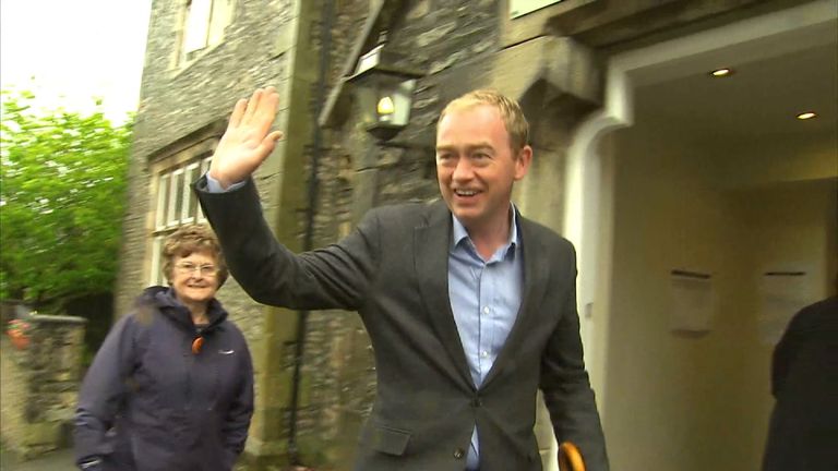 Tim Farron waves to the cameras before casting his vote
