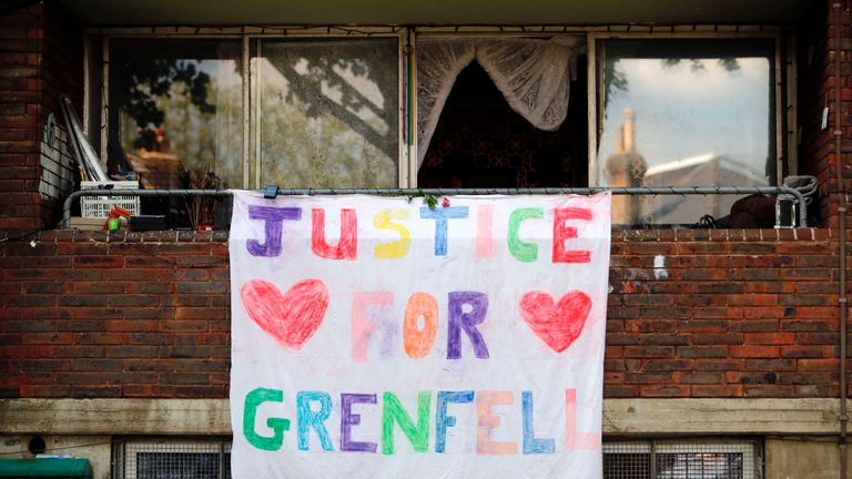 A poster hangs outside a building calling for &#39;Justice for Grenfell&#39;, justice for victims of the June 14 Grenfell Tower block fire, in Kensington, west London, on June 17, 2017