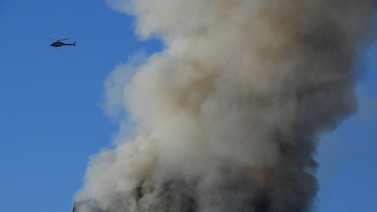 Flames and smoke billow from a tower block at Latimer Road in West London