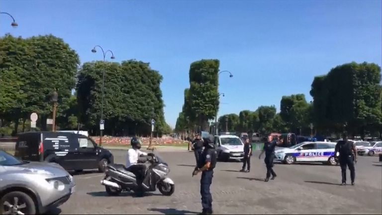 Police redirect traffic following an &#39;incident&#39; involving a car on the Champs-Elysees