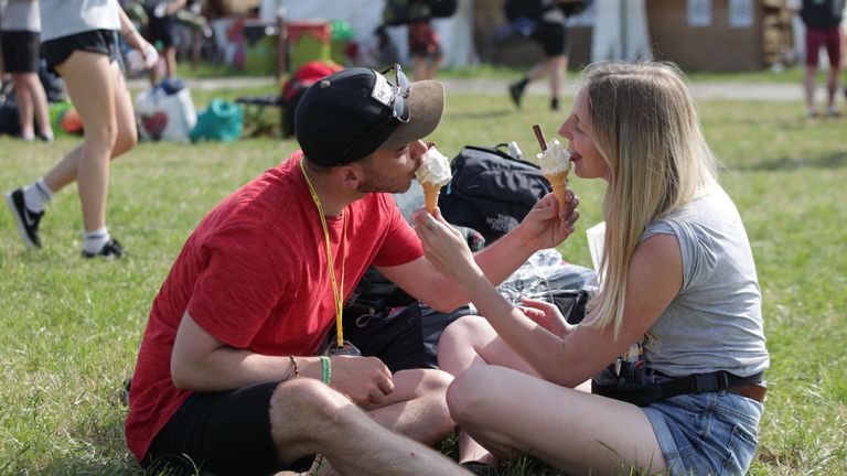 Revellers having ice cream at the Glastonbury Festival at Worthy Farm in Pilton, Somerset. 