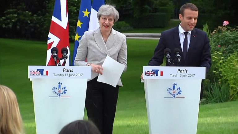 Theresa May&#39;s papers flutter away in the breeze during joint press conference with Emmanuel Macron