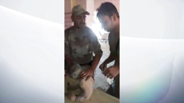 Iraqi soldiers find a boy alone in a bombed out school in Old Mosul