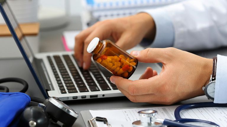 A file picture of a doctor or scientist holding medicine