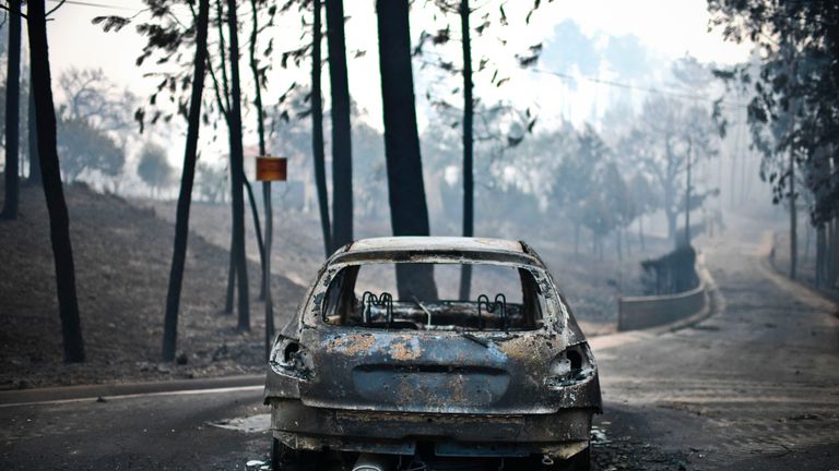 A burnt car on a road in Pedrogao, central Portugal
