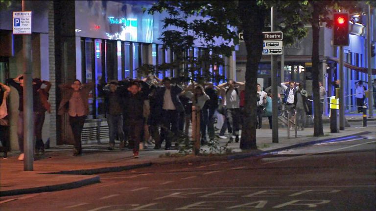 Police order members of the public to exit a cordon near London Bridge
