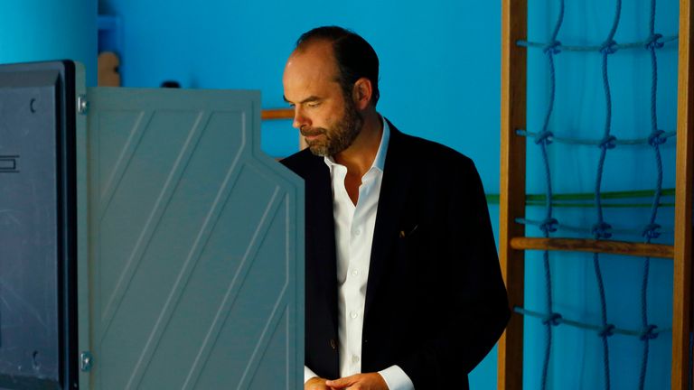 Prime Minister Edouard Philippe casts his electronic vote at a polling station
