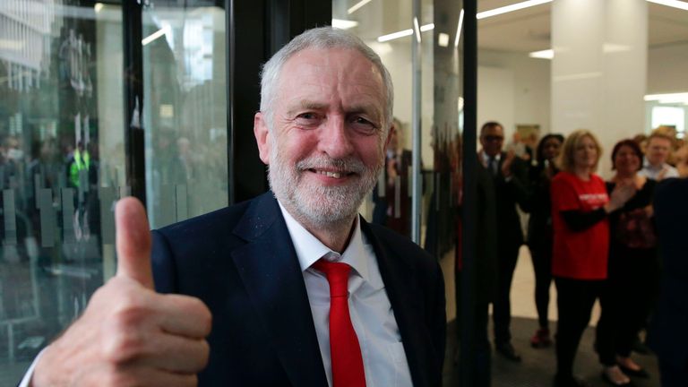 Jeremy Corbyn gives a thumbs up as he arrives at Labour HQ