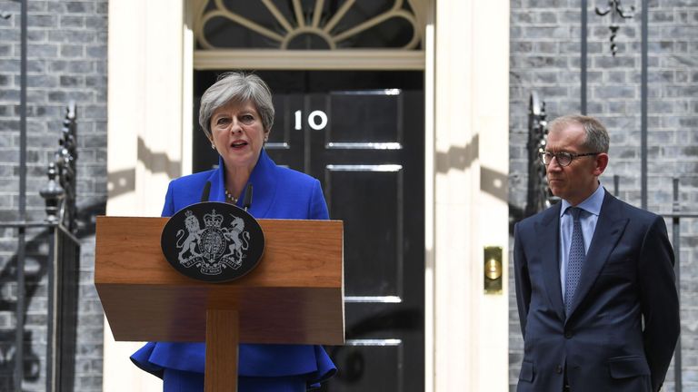 Theresa May, accompanied by her husband Philip, delivers a statement outside 10 Downing Street