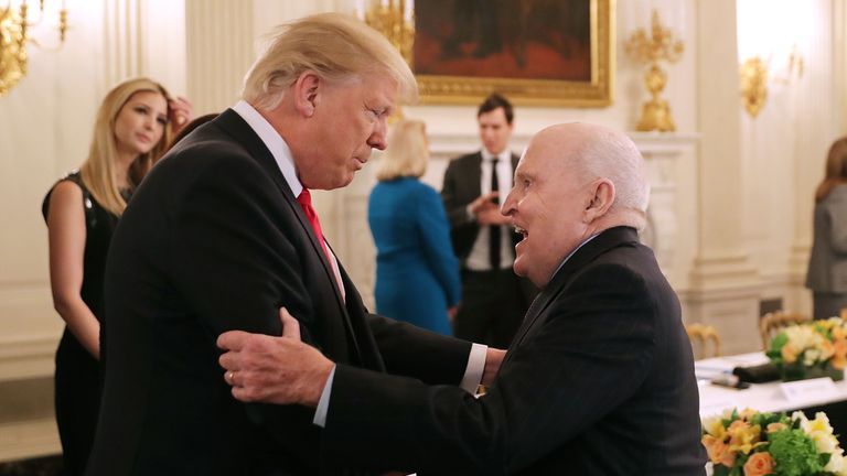 US President Donald Trump greets former General Electric CEO Jack Welch