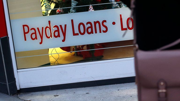 A payday loans sign is seen in the window of Speedy Cash in northwest London