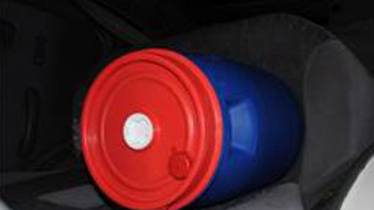 The blue and red barrels were stored in the white Nissan Micra