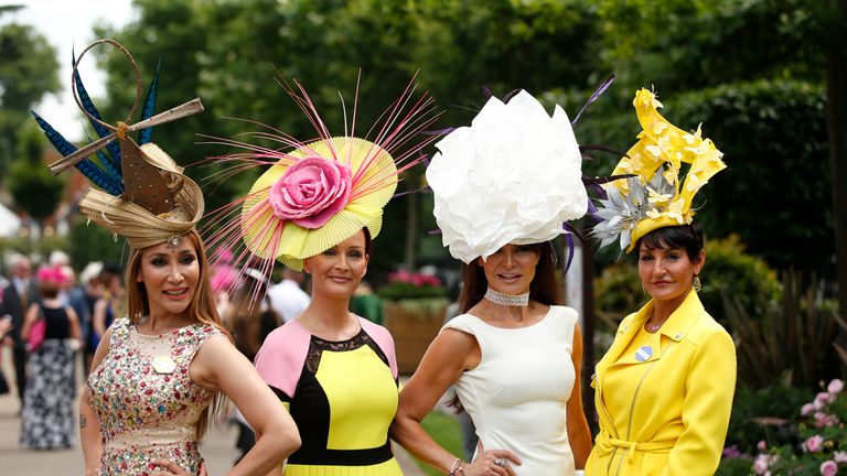 Racegoers pose before the races 