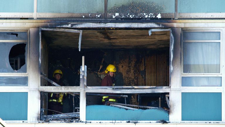 Firefighters check out a ruined flat in Lakanal House