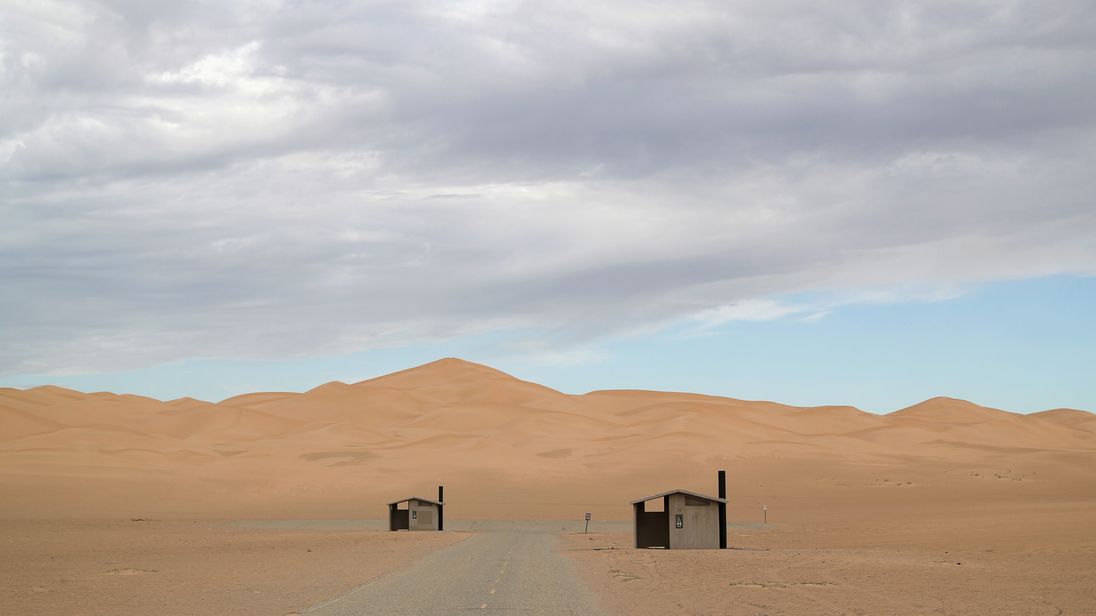 IMPERIAL SAND DUNES, CA - SEPTEMBER 27: Restrooms stand at the ready for campers near the U.S.-Mexico border fence on September 27, 2016 in the Imperial Sand Dunes recreation area, California. The border stretches almost 2,000 miles between Mexico and the United States. Border security and immigration issues have become major issues in the U.S. Presidential campaign. (Photo by John Moore/Getty Images)