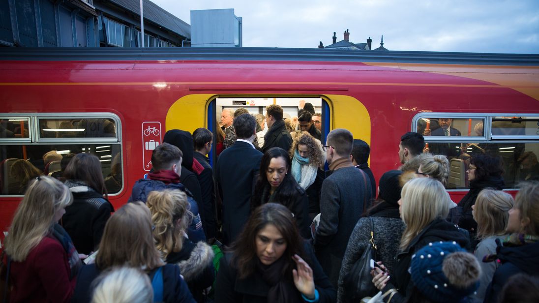Commuters attempt to board a full Southwest Train carriage