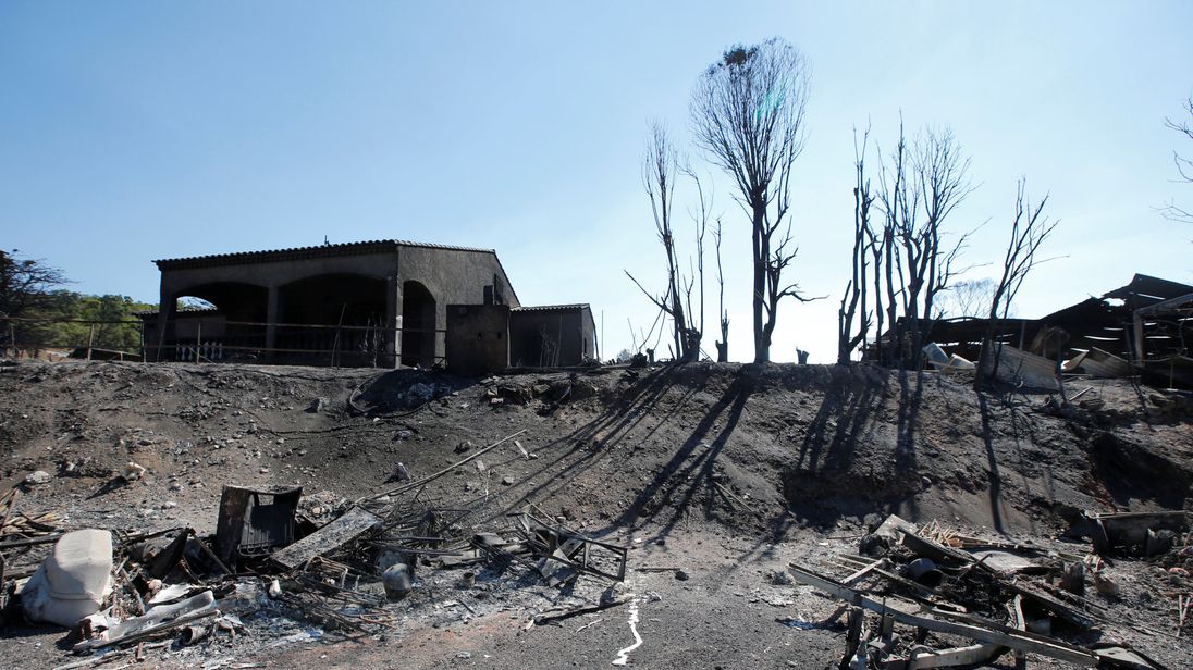 The charred debris of vehicles and buildings destroyed by fire in Bormes-les-Mimosas, in the Var department, France