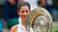 Spain's Garbine Muguruza poses with The Venus Rosewater Dish as she celebrates beating US player Venus Williams to win the women's singles final