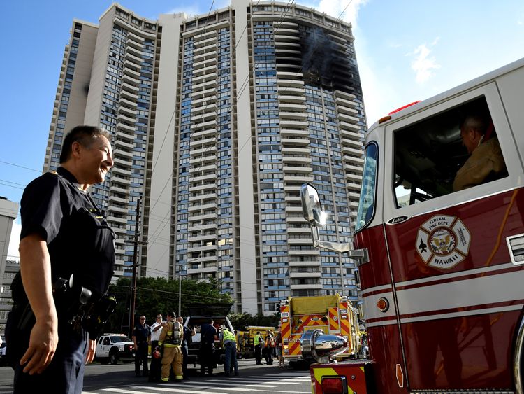 USAA police officer directs a fire truck at the Marco Polo apartment building after a fire broke out in it in Honolulu, Hawaii, July 14, 2017