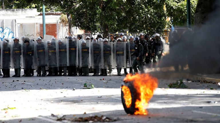 Riot security force members take cover