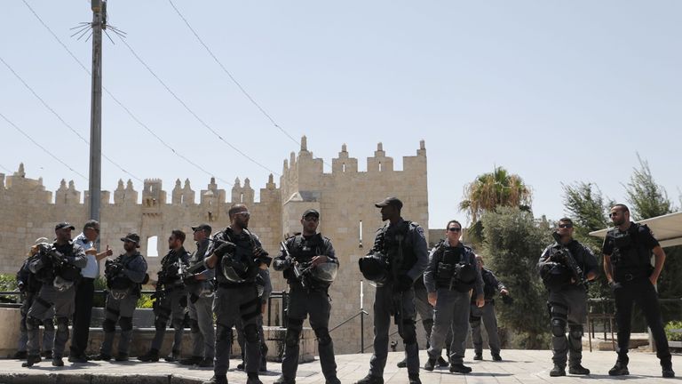 Israeli security forces stand guard following a shooting that left two officers dead