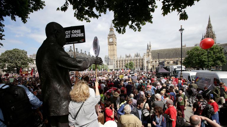 People converge on Parliament Square after marching through London in an anti-austerity protest