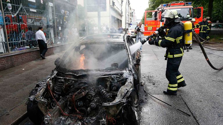 A firefighter works at the scene where a number of cars burnt down during the G20 summit in Hamburg
