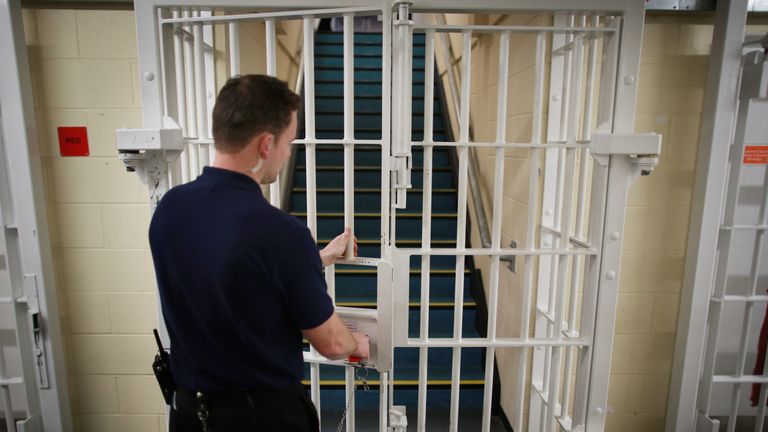 A guard closes a door in a prison. File picture