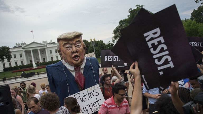 Protesters brand Mr Trump &#39;Putin&#39;s puppet&#39; during a protest outside the White House