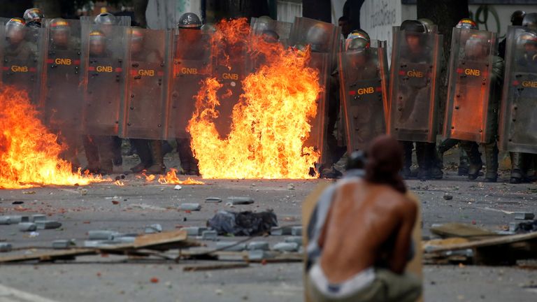 Demonstrators clash with riot security forces at a rally during a strike to protest against Venezuelan President Nicolas Maduro&#39;s government in Caracas