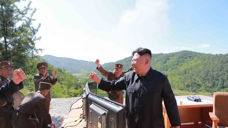Kim Jong-Un celebrates the launch with military officers