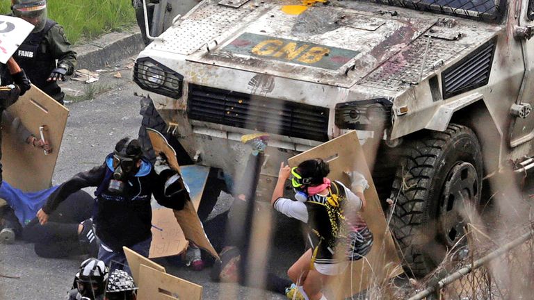 An armored vehicle hits demonstrators during clashes at a rally against Venezuelan President Nicolas Maduro's government in Caracas