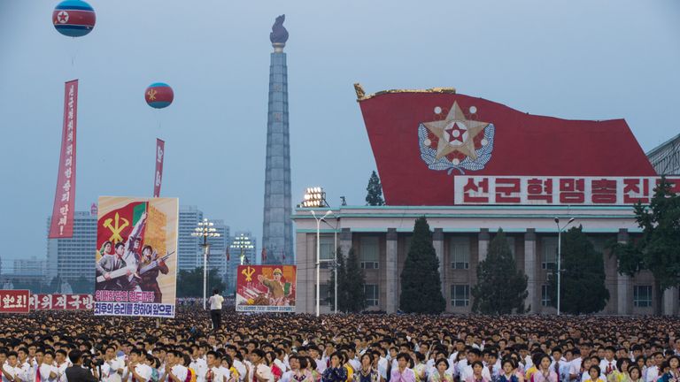 North Koreans celebrate the launch of an intercontinental ballistic missile