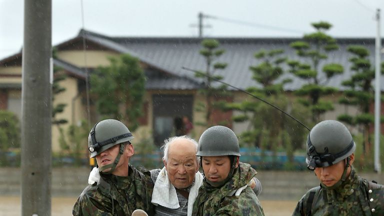 Japanese soldiers help residents to safety