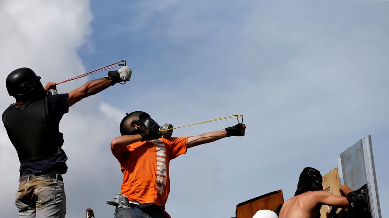 Demonstrators use slingshots during clashes 