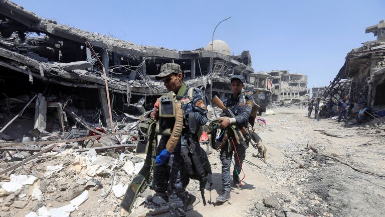 Members of Iraqi Federal police carry suicide belts used by Islamic State militants