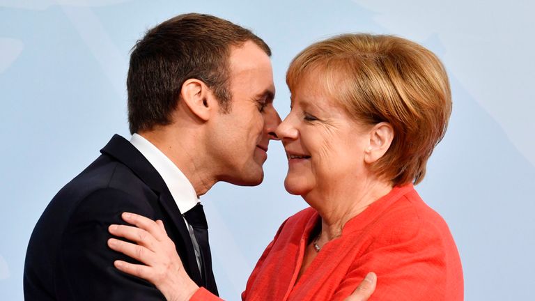 German Chancellor Angela Merkel greets French President Emmanuel Macron 