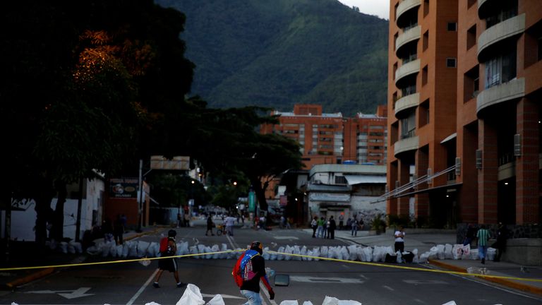 Demonstrators pass through a roadblock 