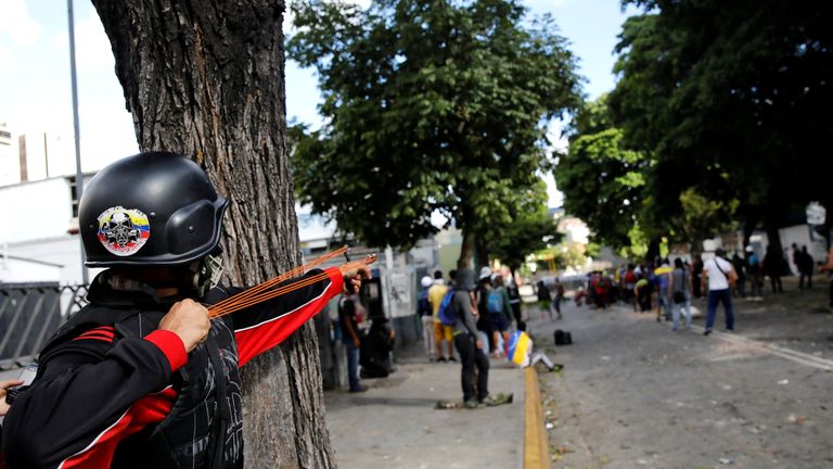 A demonstrator uses a slingshot 