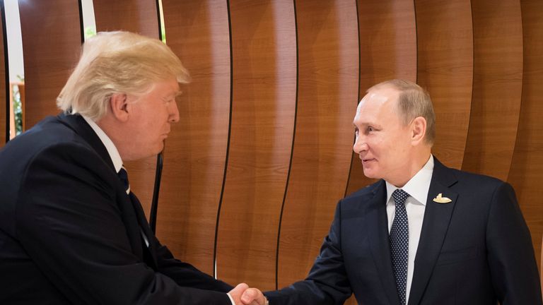 U.S. President Donald Trump and Russia&#39;s President Vladimir Putin shake hands 