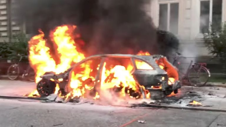 A car is seen on fire during anti-G20 protests in Hamburg, Germany. Pic: Youtube/Fasttorwa