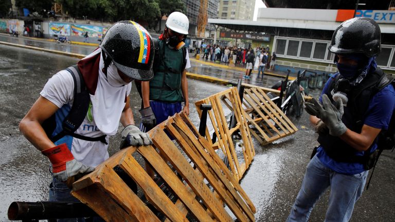 Demonstrators build a barricade