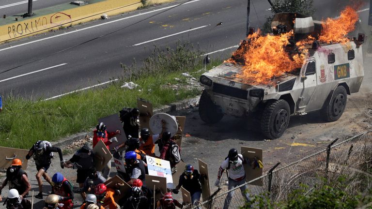 An armored vehicle on fire during clashes with demonstrators 
