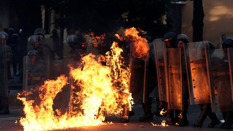Riot security forces are set on fire