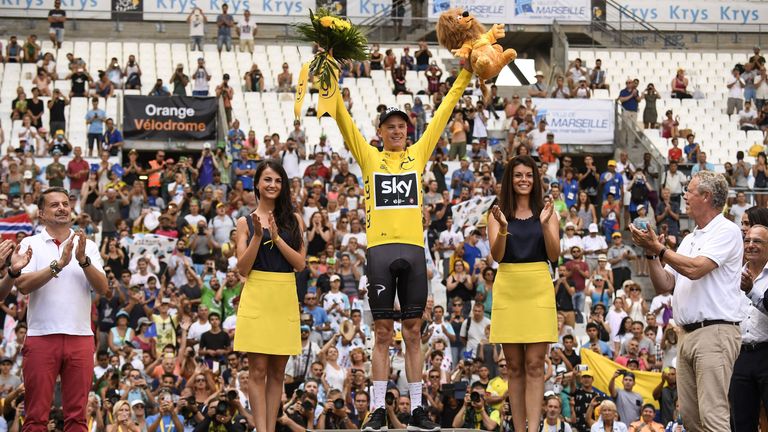 Chris Froome celebrates after holding on to the yellow jersey on penultimate stage of Tour de France.
