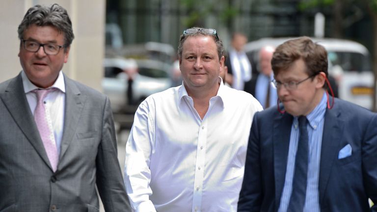 The billionaire (centre) pictured arriving at the court in central London