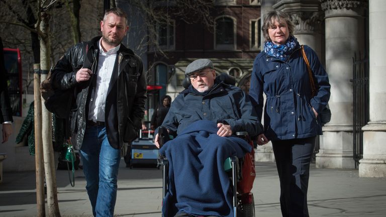 Noel Conway, 67, who suffers from motor neurone disease, arrives at the Royal Courts of Justice in London where he is seeking a judicial review in his fight for the right to have the option of an assisted death, with his wife Carol (right) and stepson Terry McCusker (left).