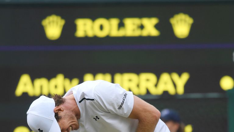 Murray grimaces in pain during his quarter final