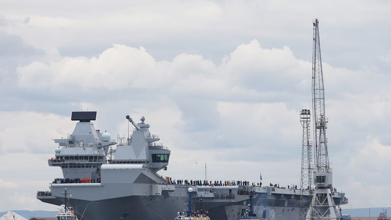 HMS Queen Elizabeth, one of two new aircraft carriers for the Royal Navy, begins to leave the Rosyth dockyard near Edinburgh to begin her sea worthiness trials