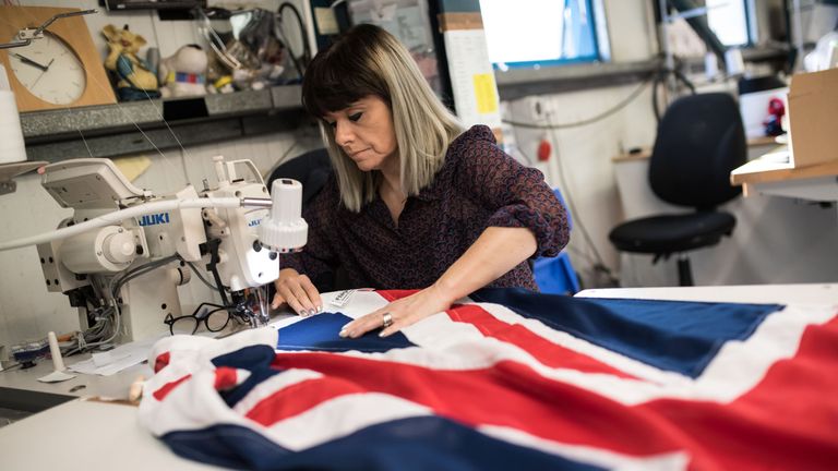 A flag manufacturer stitches and finishes a Union Flag at the factory of 'Flagmakers' in Chesterfield, northern England on March 24, 2017